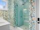 Bathroom with a frameless glass shower, colorful wallpaper, and a white vanity featuring double sinks at 2928 Baywood Dr, Seabrook Island, SC 29455