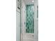 Walk-in shower featuring unique green accent tile and a glass door at 2928 Baywood Dr, Seabrook Island, SC 29455