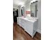 Bathroom featuring a double sink vanity with white cabinets, hardwood floors and natural lighting at 299 Hobcaw Dr, Mount Pleasant, SC 29464