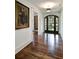 Elegant entryway with hardwood floors, arched doorway, and designer light fixture at 299 Hobcaw Dr, Mount Pleasant, SC 29464