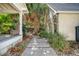 Exterior home view shows a walkway leading to an inviting porch with a chair, and lush plantings at 299 Hobcaw Dr, Mount Pleasant, SC 29464