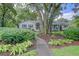 Charming single-story home with mature trees, lush landscaping and welcoming front porch at 299 Hobcaw Dr, Mount Pleasant, SC 29464