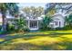 Charming home with a large front porch nestled in the shade of palm trees at 299 Hobcaw Dr, Mount Pleasant, SC 29464