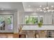 Gourmet kitchen features a large island with seating, custom cabinets, and a view of the backyard at 299 Hobcaw Dr, Mount Pleasant, SC 29464