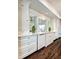 Bright kitchen boasts white cabinets, marble countertops, stainless steel appliances, and hardwood floors at 299 Hobcaw Dr, Mount Pleasant, SC 29464