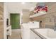 Bright laundry room featuring white washer and dryer, a sink, storage, and neutral wood plank walls at 299 Hobcaw Dr, Mount Pleasant, SC 29464