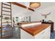 Open living area with a ladder to the loft and high-end wood countertops on the kitchen island at 299 Hobcaw Dr, Mount Pleasant, SC 29464