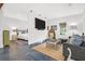 An open-concept living room and bedroom featuring modern decor, neutral colors and stained concrete floors at 299 Hobcaw Dr, Mount Pleasant, SC 29464