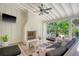 Inviting covered patio with a stone fireplace, comfortable seating, and serene garden views at 299 Hobcaw Dr, Mount Pleasant, SC 29464