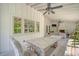 Cozy outdoor patio with a rustic wooden table, a ceiling fan, and peaceful backyard views at 299 Hobcaw Dr, Mount Pleasant, SC 29464