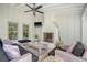 Inviting patio with a stone fireplace, comfortable seating, and a ceiling fan at 299 Hobcaw Dr, Mount Pleasant, SC 29464