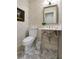 Stylish powder room featuring patterned wallpaper, a classic pedestal sink, and marble herringbone floors at 299 Hobcaw Dr, Mount Pleasant, SC 29464