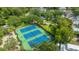 Aerial view of well-maintained tennis courts surrounded by residential neighborhood and mature trees at 313 Queen St, Mount Pleasant, SC 29464
