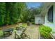 The backyard has brick pavers, a seating area with a fire pit, and lush bamboo at 313 Queen St, Mount Pleasant, SC 29464