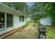 Charming brick patio with lush landscaping, grill, and access to the main house at 313 Queen St, Mount Pleasant, SC 29464