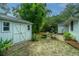 Charming backyard featuring a storage shed, fire pit, brick patio, and lush bamboo at 313 Queen St, Mount Pleasant, SC 29464