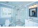 Bathroom featuring a glass-enclosed shower, mosaic tile, and a classic vanity at 313 Queen St, Mount Pleasant, SC 29464