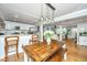 Bright dining area connects kitchen and living room, featuring wooden table, pendant lights, and seamless flow, great for gatherings at 313 Queen St, Mount Pleasant, SC 29464