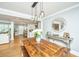 Inviting dining room with hardwood floors, decorative mirror, and seamless flow into living area, ideal for entertaining guests at 313 Queen St, Mount Pleasant, SC 29464