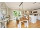 Charming dining area with a rustic wooden table, pendant lighting, and access to the outdoors, perfect for Gathering gatherings at 313 Queen St, Mount Pleasant, SC 29464
