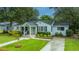 Aerial view of a charming single-story house with lush green lawn and mature trees at 313 Queen St, Mount Pleasant, SC 29464