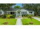 Aerial view showcasing a charming home, manicured lawn, and inviting walkway at 313 Queen St, Mount Pleasant, SC 29464