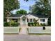 Charming home with a neatly landscaped yard, white picket fence and a welcoming front porch at 313 Queen St, Mount Pleasant, SC 29464