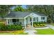 Aerial shot showcases this home with a quaint porch, lush greenery and manicured lawn at 313 Queen St, Mount Pleasant, SC 29464