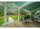 Inviting front porch featuring cozy seating and a view of the manicured lawn at 313 Queen St, Mount Pleasant, SC 29464