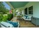 Cozy front porch with ample seating, perfect for relaxing and enjoying the neighborhood views at 313 Queen St, Mount Pleasant, SC 29464