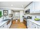 Efficient kitchen boasts white cabinets, subway tile backsplash, stainless steel appliances, and ample counter space for meal preparation at 313 Queen St, Mount Pleasant, SC 29464