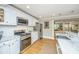 Modern kitchen with stainless steel appliances, white cabinets, and an open floor plan at 313 Queen St, Mount Pleasant, SC 29464