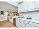 Bright kitchen features white cabinets, stainless steel appliances, and marble countertops at 313 Queen St, Mount Pleasant, SC 29464