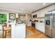 Bright kitchen features white cabinets, stainless steel appliances, marble countertops, and seamless flow, great for cooking and dining at 313 Queen St, Mount Pleasant, SC 29464