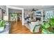 Open-concept living room with hardwood floors, fireplace, and abundant natural light at 313 Queen St, Mount Pleasant, SC 29464