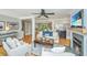 Open-concept living room with fireplace, comfortable seating, wood floors, and seamless flow into dining area for easy entertaining at 313 Queen St, Mount Pleasant, SC 29464