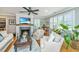 Bright living room featuring a fireplace, hardwood floors, neutral color palette, and plantation shutters for a cozy ambiance at 313 Queen St, Mount Pleasant, SC 29464