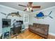 Bright office space with hardwood floors, ceiling fan, and bright windows with white shutters at 313 Queen St, Mount Pleasant, SC 29464