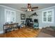 Well-lit office with hardwood floors, ceiling fan, and bright windows with white shutters at 313 Queen St, Mount Pleasant, SC 29464