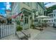 Charming restaurant exterior with outdoor seating, white picket fence, and blue trim at 313 Queen St, Mount Pleasant, SC 29464