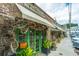 Charming brick storefront featuring a green door, decorative plants and sidewalk retail at 313 Queen St, Mount Pleasant, SC 29464