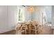 Inviting dining room with a rustic wooden table, stylish chairs, and a modern light fixture at 321 Pine Crest View Dr, Summerville, SC 29486