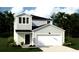 Charming two-story home featuring light blue siding, a two-car garage, and inviting curb appeal at 321 Pine Crest View Dr, Summerville, SC 29486