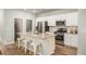 Bright kitchen featuring white cabinets, a granite island with barstool seating, and stainless steel appliances at 321 Pine Crest View Dr, Summerville, SC 29486