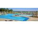 Community swimming pool with lounge chairs, umbrellas, and splash pad at 321 Pine Crest View Dr, Summerville, SC 29486