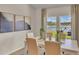 Bright dining room with large windows overlooking a serene water view, modern decorations, and tile flooring at 334 Pine Crest View Dr, Summerville, SC 29486