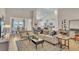 Open-concept living room with modern furnishings, wood floors, and ample natural light at 334 Pine Crest View Dr, Summerville, SC 29486