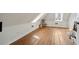 Attic room with sloped ceiling, hardwood floors, storage, and natural light at 38 State St # 2, Charleston, SC 29401