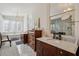 Bathroom with marble floors, antique wooden cabinets, and soaking tub at 38 State St # 2, Charleston, SC 29401