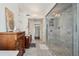 Bathroom with an enclosed shower, tile flooring, and traditional wooden storage at 38 State St # 2, Charleston, SC 29401